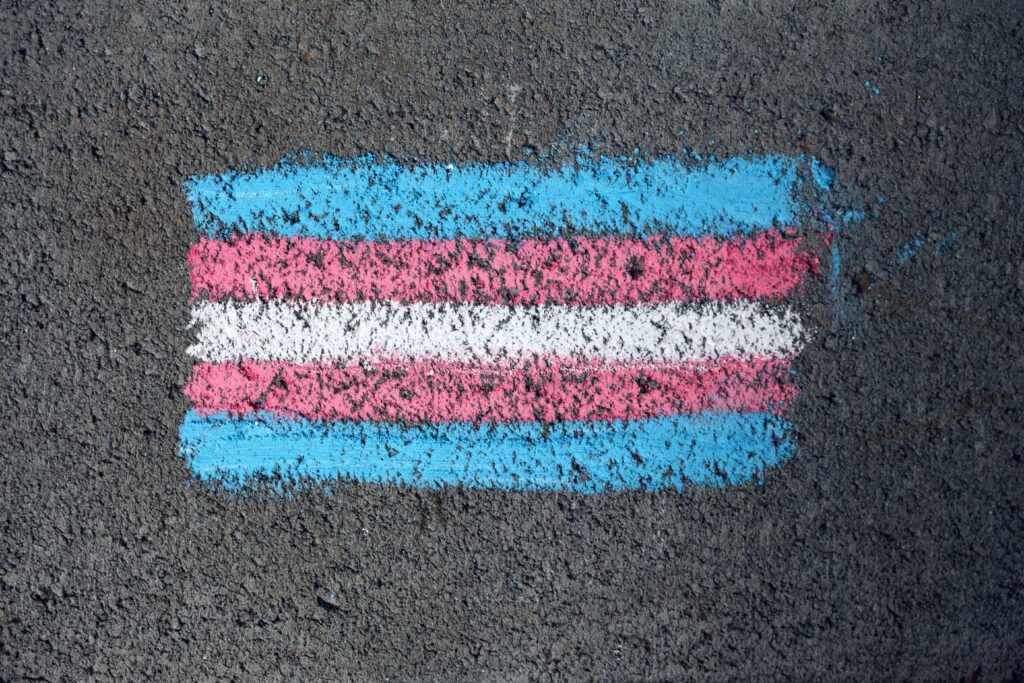 A drawing of the transgender flag on concrete