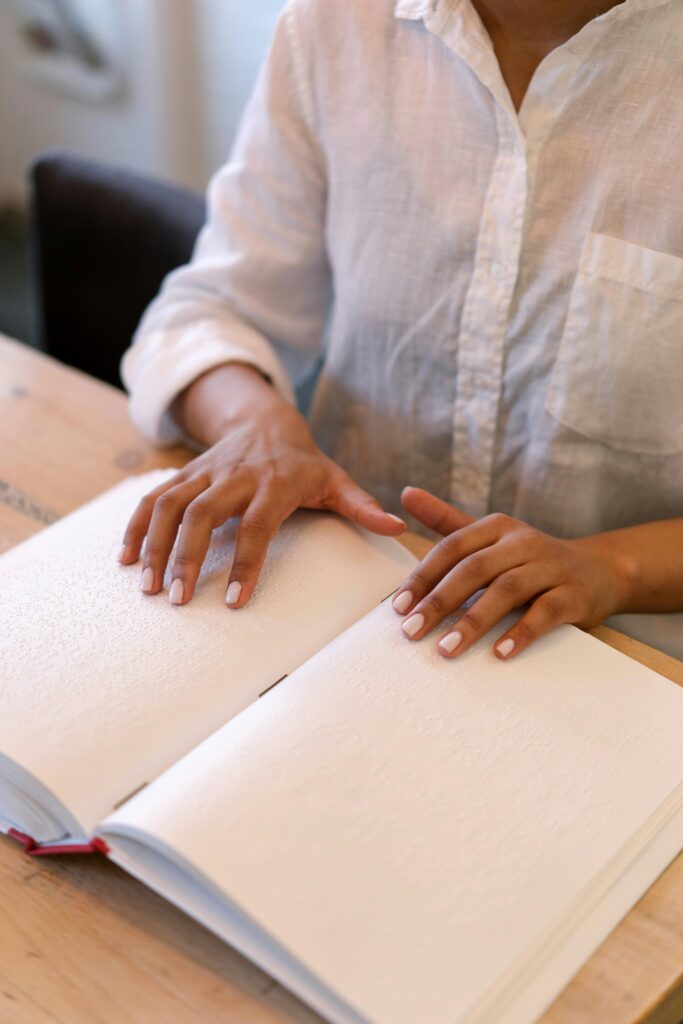 A person reading braille on a book